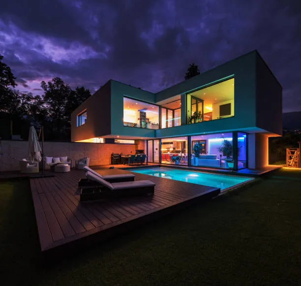 Modern villa with colored led lights at night.