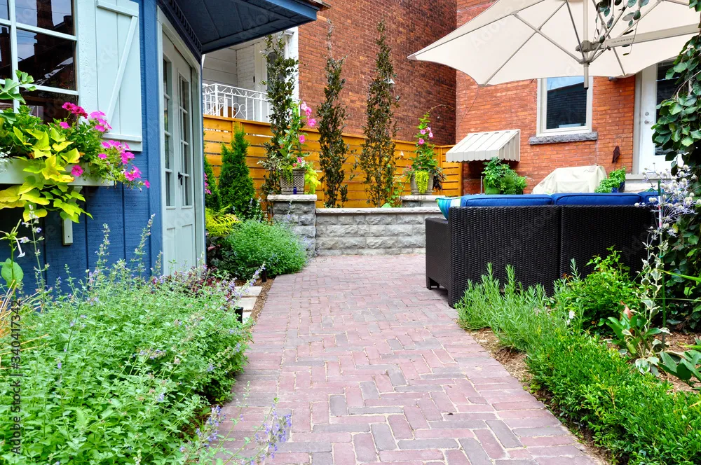 paved walkway urban garden with patio furniture