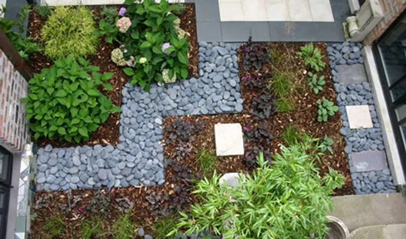 Overhead view of a planted landscape bed with stone accents