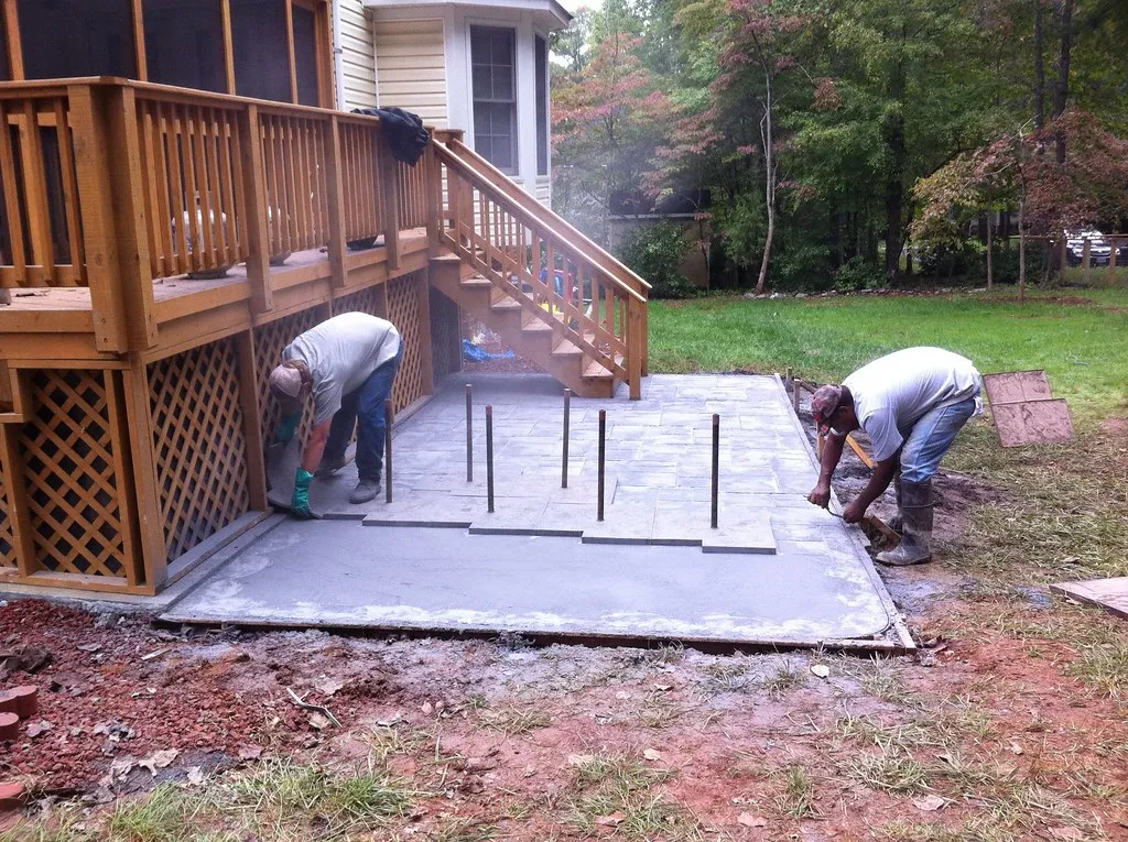 professionals stamping concrete in the backyard
