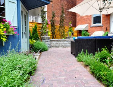 paved walkway urban garden with patio furniture